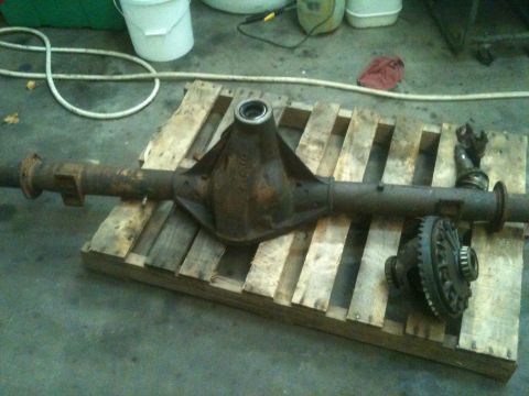 1992 Jeep YJ - A rusty rear axle assembly and a separate differential are shown resting on a wooden pallet.
