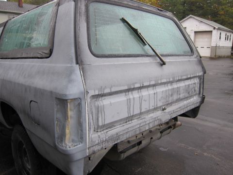 1987 Dodge 1500 - This SUV appears to be undergoing bodywork, with a missing taillight and a dirty, streaky finish.