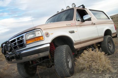 1996 Ford Bronco - This lifted 1996 Ford Bronco features a two-tone paint scheme and off-road accessories, including a front bull bar and multiple roof-mounte…