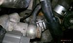 1994 Ford Probe - This image shows a close-up view of an engine component, likely a thermostat housing, with associated hoses and electrical connectors.