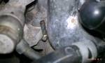 1994 Ford Probe - Close-up view of engine components, including hoses and metal parts.