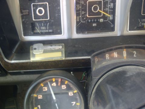 1979 Ford E250 - The dashboard of a 1979 Ford E250 van shows the fuel gauge, speedometer, tachometer, and gear selector.