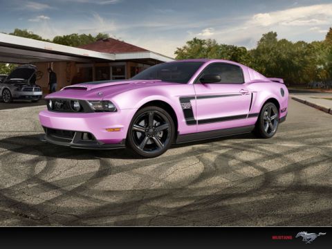 2012 Ford Mustang - A pink 2012 Ford Mustang Boss 302 is parked outside a building, with another Mustang visible in the background.