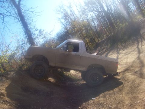 1989 Ford Bronco - This 1989 Ford Bronco navigates a steep, muddy incline on an off-road trail.