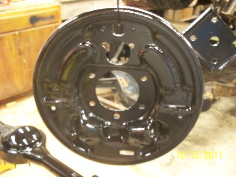 1990 Ford Bronco - Close-up of a freshly painted brake backing plate and axle housing, likely for a vehicle restoration project.