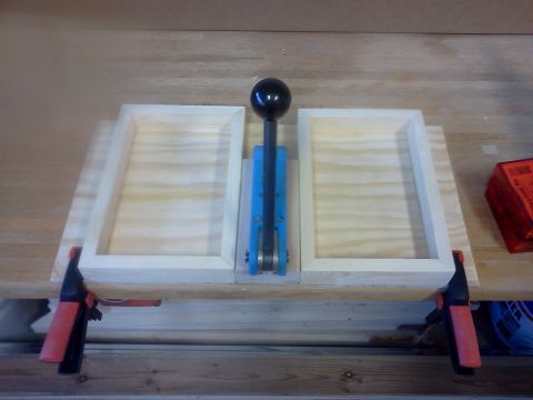 1996 Ford Bronco - A reloading press is set up on a workbench with wooden frames and clamps.