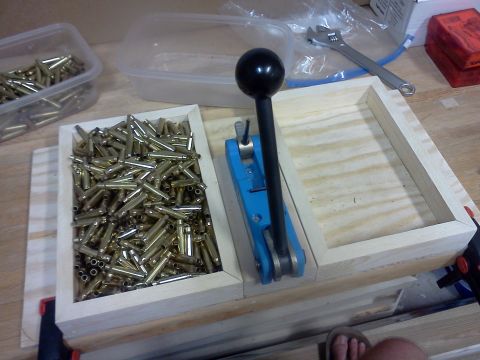 1996 Ford Bronco - Reloading press and brass casings on a workbench, with tools in the background.