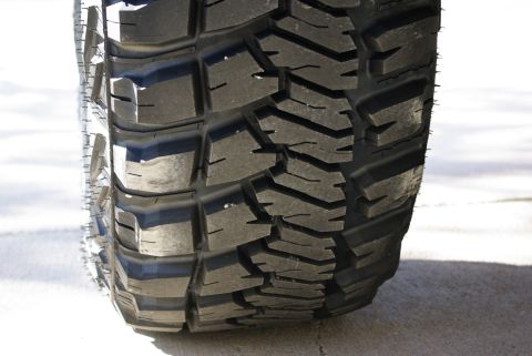1995 Ford Bronco - Tire tread detail, showing deep grooves and blocky pattern for off-road traction.
