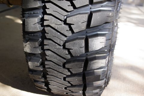 1995 Ford Bronco - A detailed view of a tire's tread pattern, highlighting its robust design for off-road use.