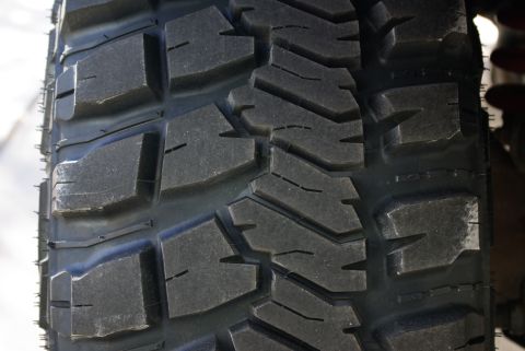 1995 Ford Bronco - Close-up view of the tread pattern on an off-road tire.