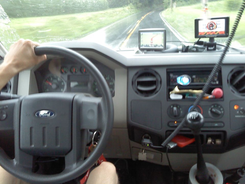 Driver view of a Ford truck dashboard and steering wheel in rain