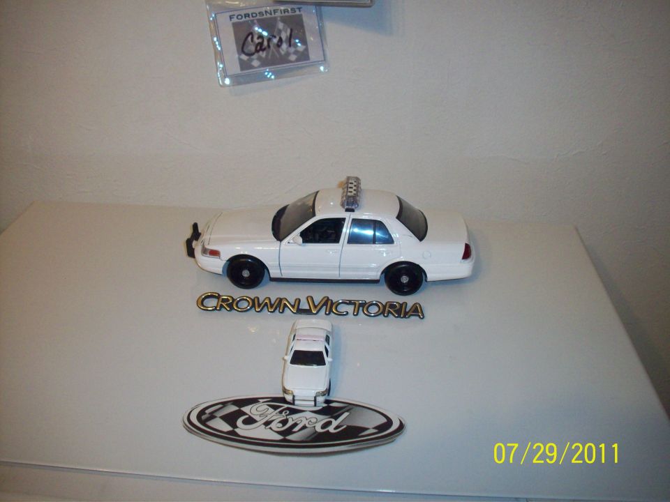 White toy police car with light bar and Crown Victoria badging