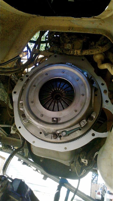 1995 Ford F-150 - Underside view of a vehicle's clutch assembly, showing the flywheel and pressure plate.