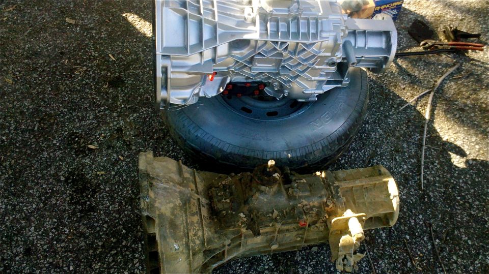 Clean and dirty transmissions side-by-side on asphalt
