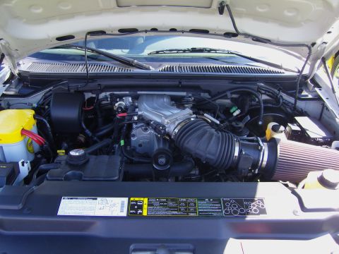 2007 Ford Mustang - Close-up of a vehicle's engine bay, a supercharger and custom air intake system.