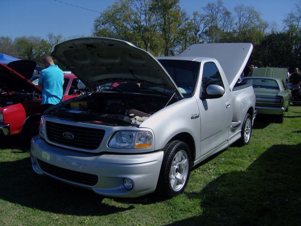 Silver 2007 Ford F-150 SVT Lightning pickup truck, front 3/4 view, hoods open