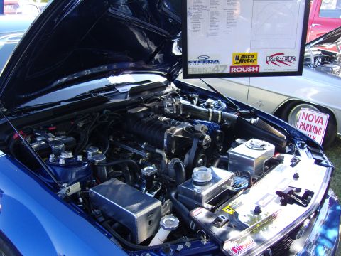 2007 Ford Mustang - Close-up of a modified engine bay, a prominent supercharger and custom components.