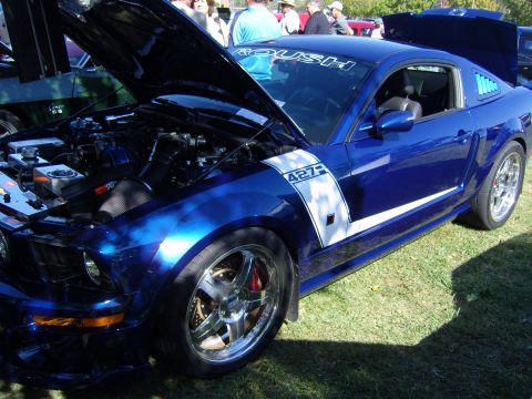 2007 Ford Mustang - A blue Ford Mustang with racing stripes and '427' badging is displayed with its hood open.