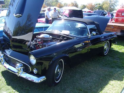 2007 Ford Mustang - A classic black 1955 Ford Thunderbird convertible is displayed with its hood open at an outdoor event.