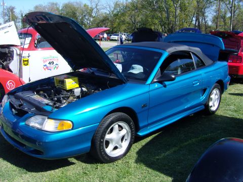 2007 Ford Mustang - A blue convertible is parked on grass with its hood open, revealing the engine compartment.