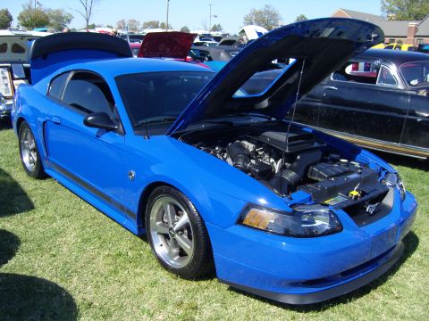 2007 Ford Mustang - Blue 2007 Ford Mustang at a car show, engine exposed for viewing.