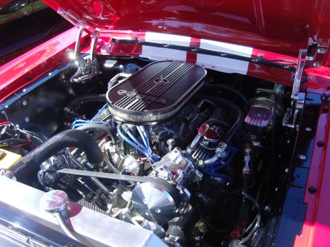 2007 Ford Mustang - The engine bay of a red 1967 Ford Mustang, a Cobra air cleaner and racing stripes.