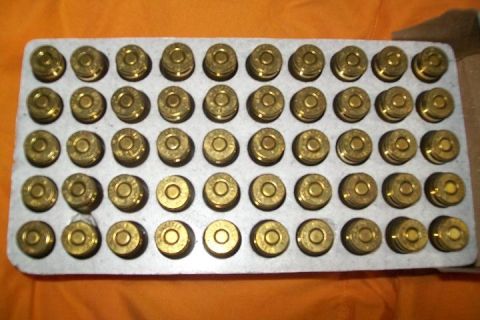 2000 Chevrolet Tahoe - A tray holding many brass ammunition cartridges, likely for a firearm.