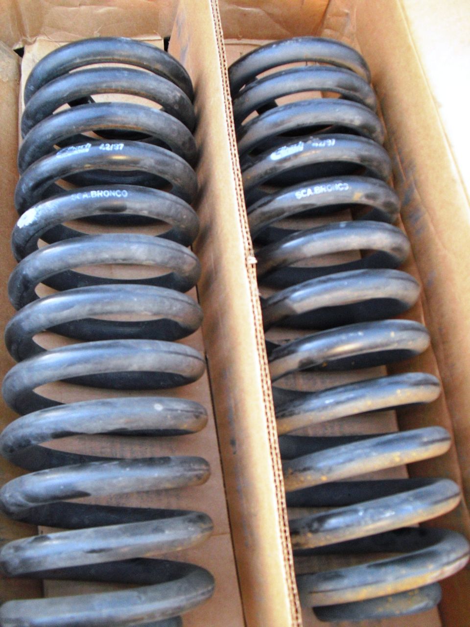 Two boxes of Eibach springs, one box has 'BRONCO' printed on it