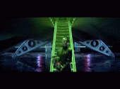 2000 Mercury Grand Marquis - A person in a green suit ascends a glowing green staircase in a dark, futuristic setting.