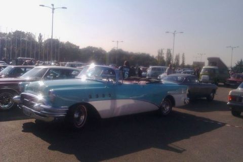 1991 Ford LTD Crown Victoria - A classic two-tone blue and white convertible, likely a 1955 model, is parked at an outdoor car show.
