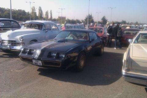 1991 Ford LTD Crown Victoria - A black Pontiac Firebird is parked at an outdoor car show with other vintage vehicles.