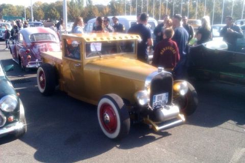 1991 Ford LTD Crown Victoria - A custom gold hot rod pickup truck is parked at an outdoor event with other vehicles and people around.