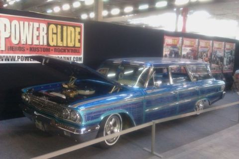 1991 Ford LTD Crown Victoria - A custom blue station wagon from the 1960s is displayed with its hood open.