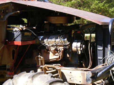 1978 Ford Bronco - Close-up of a V8 engine bay, showing the engine, battery, and radiator components.
