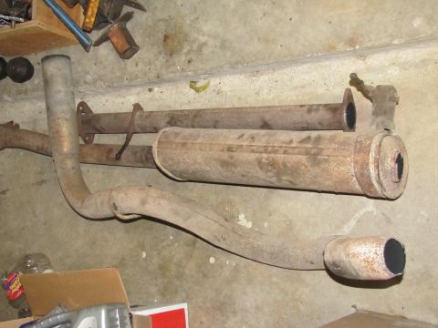 1995 Ford Bronco - These are parts of a vehicle's exhaust system, likely removed for replacement or repair.