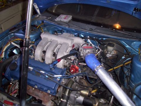 1995 Ford Probe - Close-up view of a modified engine bay, a turbocharger setup and custom paint.