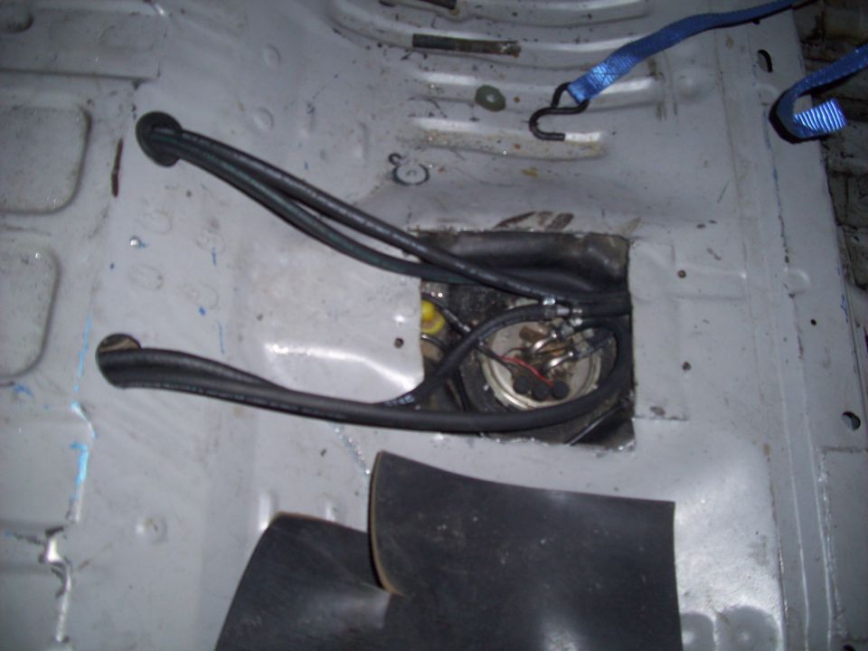 Fuel pump assembly with hoses and straps