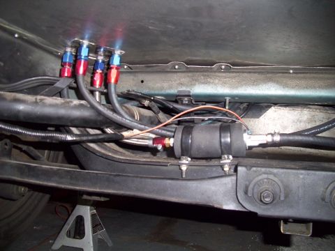 1995 Ford Probe - Custom fuel pump setup with braided lines and fittings visible under the chassis.