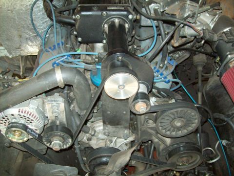 1993 Ford F-150 - Close-up view of an engine compartment, highlighting a supercharger and associated components.