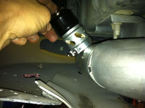 2004 Ford Crown Victoria - A close-up view of a blow-off valve being installed onto a large diameter pipe.