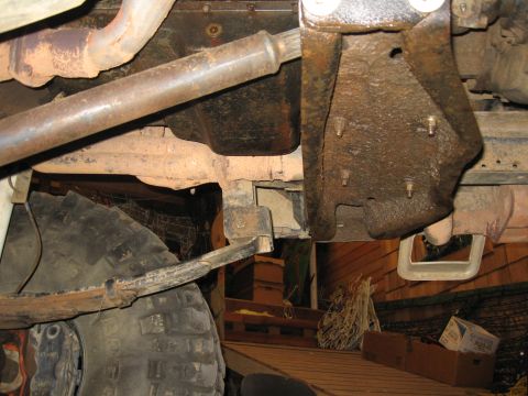 1979 Ford Bronco - Undercarriage view showing suspension components and exhaust pipes, with a tire visible on the left.