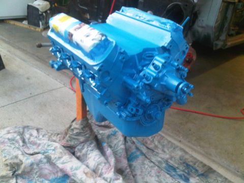 1985 Ford Bronco - A blue engine sits on an orange engine stand, covered with a patterned cloth below.