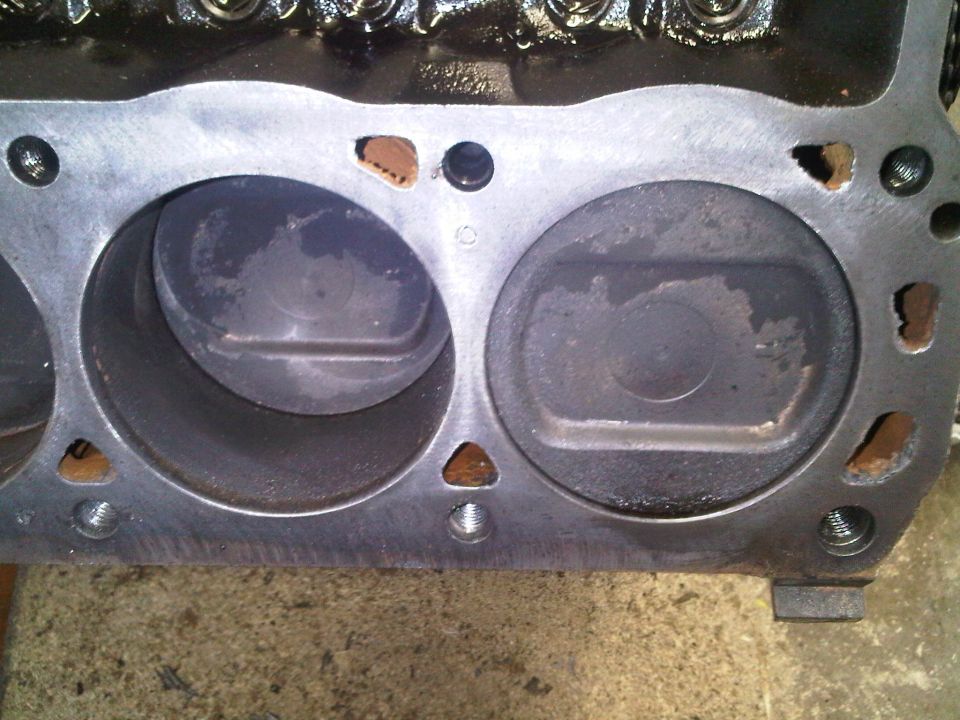 Close-up of an engine block showing two cylinders with pistons inside