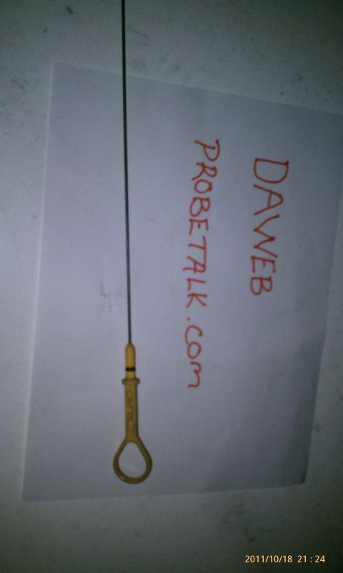 1994 Ford Probe - An oil dipstick is shown with handwritten notes on a piece of paper, including a website address.