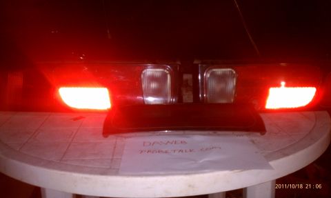 1994 Ford Probe - Close-up of car taillights, with a piece of paper bearing text placed in front of them.