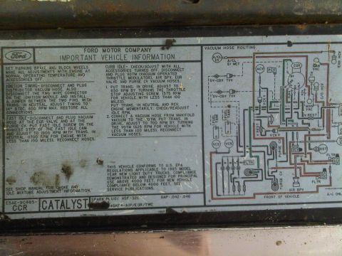 1985 Ford Bronco - Ford Important Vehicle Information (VECI) decal: base timing/idle-adjust steps (TDC, 650/700 RPM, 1900 fast idle) plus a vacuum hose routin…