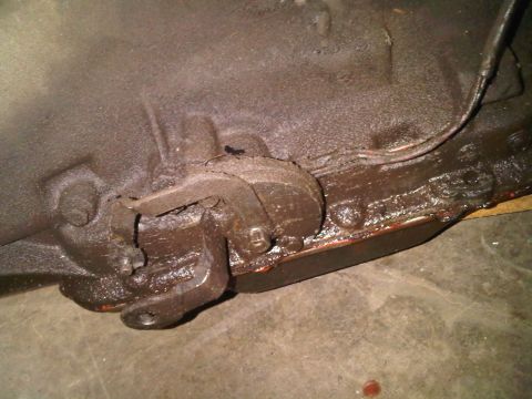 1985 Ford Bronco - This image shows a close-up view of a greasy transmission linkage mechanism.