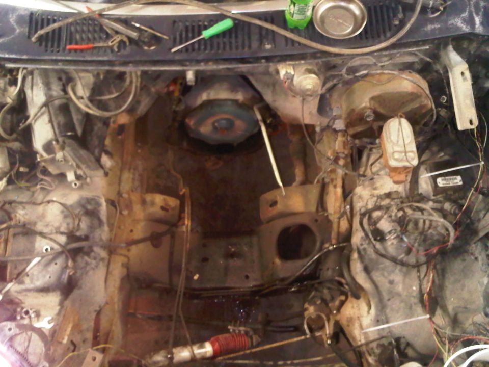Engine bay with parts removed, showing the firewall and some engine components