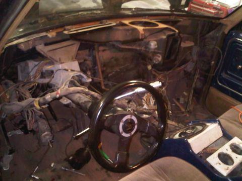 1985 Ford Bronco - Vehicle interior is in a state of disassembly, showing extensive wiring and dashboard removal.