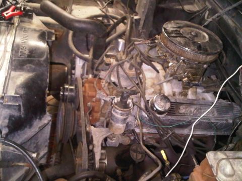 1985 Ford Bronco - Close-up view of an engine bay, showing the carburetor, radiator, and various engine components.